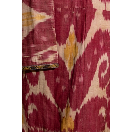 136 - An Uzbek Silk Ikat Chapan Robe, Late 19th Century.

This silk ikat robe showcases bold patterns in h... 