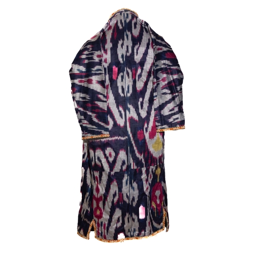 137 - An Uzbek Ikat Silk Chapan Robe, Late 19th Century.

This garment features bold ikat patterns in deep... 