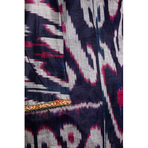 137 - An Uzbek Ikat Silk Chapan Robe, Late 19th Century.

This garment features bold ikat patterns in deep... 