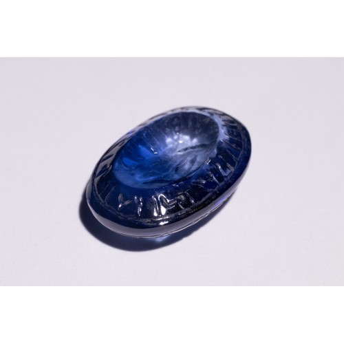 140 - An Islamic Carved Blue Gemstone, Possibly Sapphire, with Engraved Inscriptions.

This oval-shaped Is... 