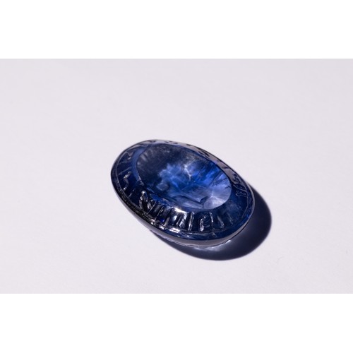 140 - An Islamic Carved Blue Gemstone, Possibly Sapphire, with Engraved Inscriptions.

This oval-shaped Is... 