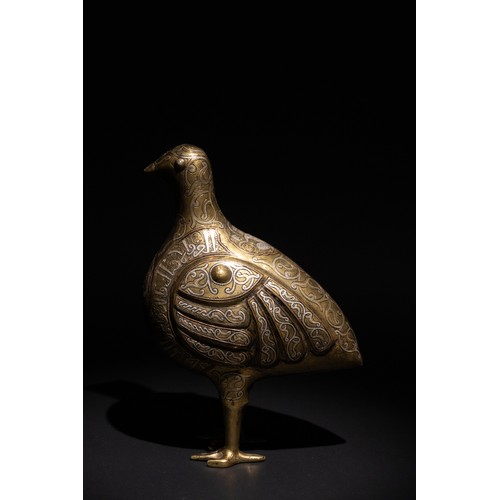 141 - An Islamic Silver Inlaid Bronze Bird, Decorated with Islamic Calligraphy.

An Islamic bronze bird ad... 