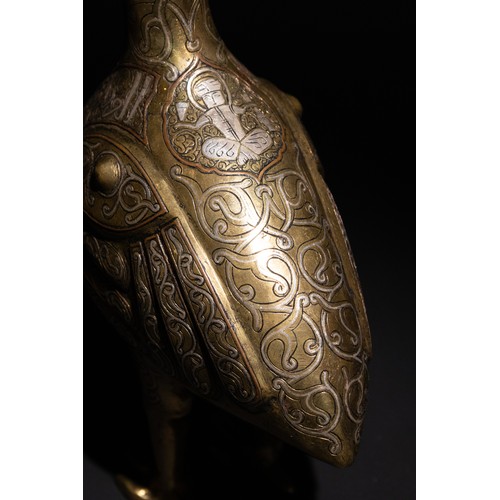 141 - An Islamic Silver Inlaid Bronze Bird, Decorated with Islamic Calligraphy.

An Islamic bronze bird ad... 