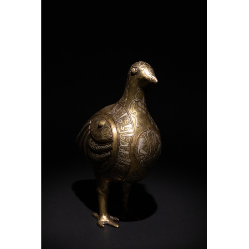 141 - An Islamic Silver Inlaid Bronze Bird, Decorated with Islamic Calligraphy.

An Islamic bronze bird ad... 