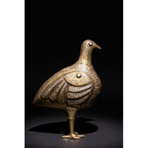 141 - An Islamic Silver Inlaid Bronze Bird, Decorated with Islamic Calligraphy.

An Islamic bronze bird ad... 