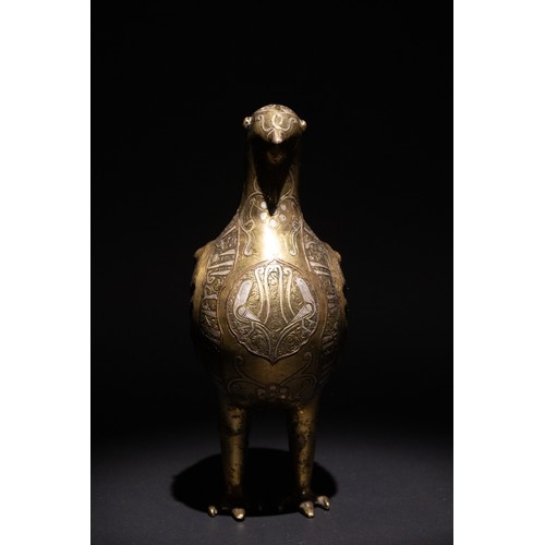 141 - An Islamic Silver Inlaid Bronze Bird, Decorated with Islamic Calligraphy.

An Islamic bronze bird ad... 