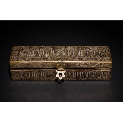 144 - An Islamic Khurasan Style Silver-Inlaid Brass Pen-Case.

A rectangular brass pen-case adorned with i... 