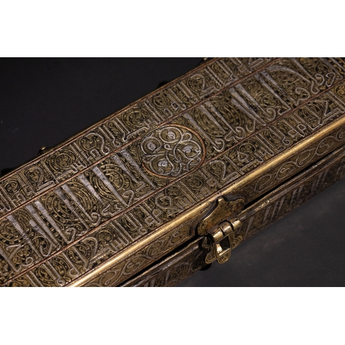 144 - An Islamic Khurasan Style Silver-Inlaid Brass Pen-Case.

A rectangular brass pen-case adorned with i... 