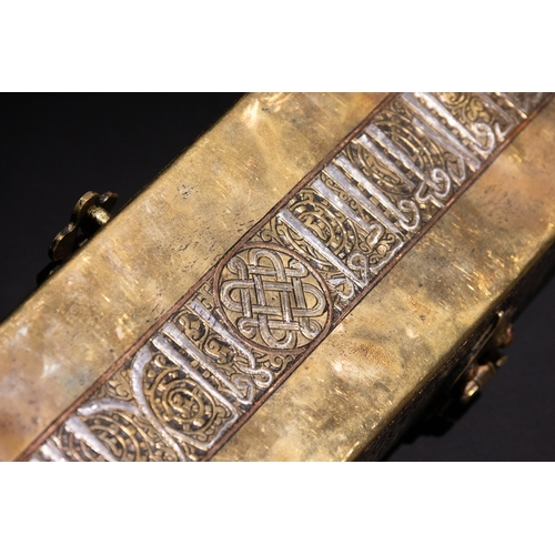 144 - An Islamic Khurasan Style Silver-Inlaid Brass Pen-Case.

A rectangular brass pen-case adorned with i... 