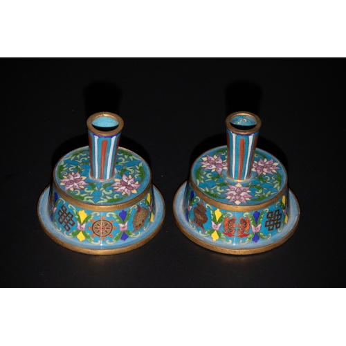 76 - A Pair of Chinese Cloisonné Enamel Candlesticks with Floral Motifs, 19th Century.

This pair of Chin... 