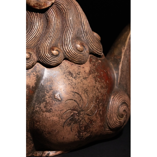 81 - A Chinese Bronze Censer in the Form of a Seated Temple Lion.

A Chinese bronze censer modelled as a ... 