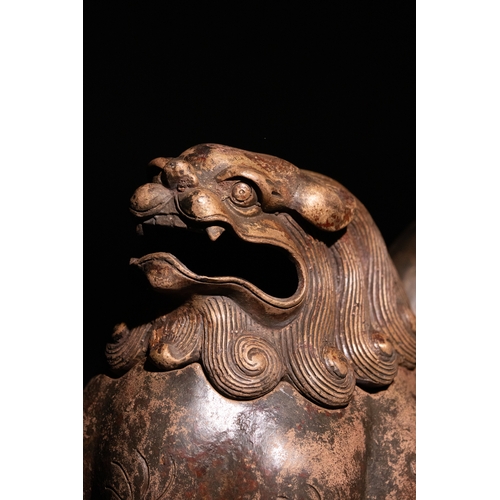 81 - A Chinese Bronze Censer in the Form of a Seated Temple Lion.

A Chinese bronze censer modelled as a ... 