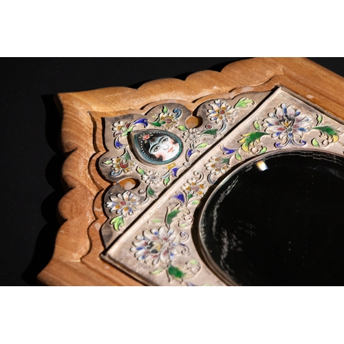 6 - A Qajar Silver and Enamel Wall Mirror.

This Qajar mirror is set within a wooden frame, featuring an... 