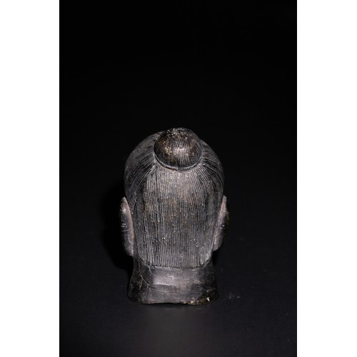 83 - A Chinese Bronze Head of a Possible Buddhist Deity. 

A bronze head depicting a serene face with sof... 