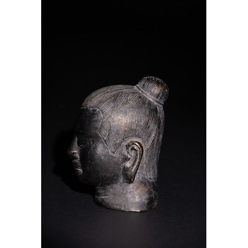 83 - A Chinese Bronze Head of a Possible Buddhist Deity. 

A bronze head depicting a serene face with sof... 