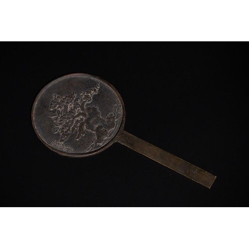 301 - **NO RESERVE** 

A Chinese Bronze Hand Mirror with Floral Relief.

A circular Chinese bronze hand mi... 