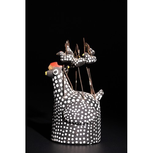 303 - **NO RESERVE**

A Central Asian Painted Clay Hen with Hanging Chicks

A clay hen painted in black wi... 