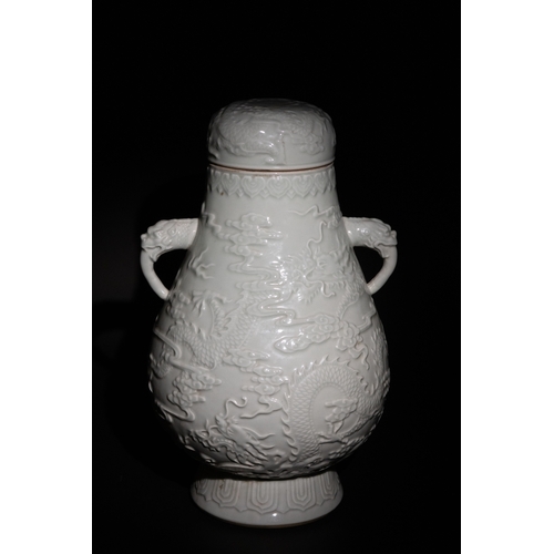 84 - A Chinese White Porcelain Twin-Handled Dragon Vase with Six Character Marks to the Base.

This Chine... 