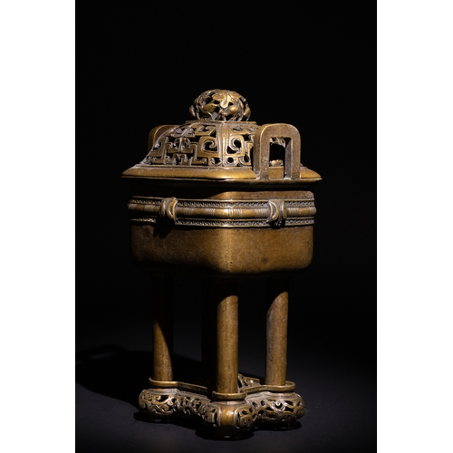 85 - A Chinese Bronze Censor with Geometric Openwork.

The burner stands on four legs, supporting a detai... 