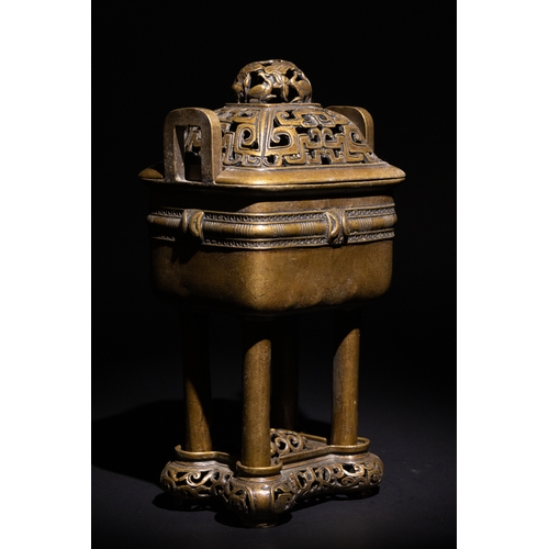85 - A Chinese Bronze Censor with Geometric Openwork.

The burner stands on four legs, supporting a detai... 