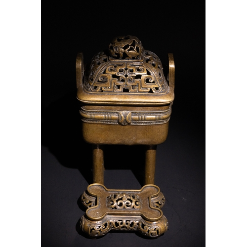 85 - A Chinese Bronze Censor with Geometric Openwork.

The burner stands on four legs, supporting a detai... 