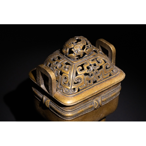 85 - A Chinese Bronze Censor with Geometric Openwork.

The burner stands on four legs, supporting a detai... 