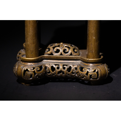 85 - A Chinese Bronze Censor with Geometric Openwork.

The burner stands on four legs, supporting a detai... 
