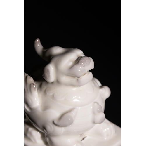 96 - A Chinese Blanc-de-Chine Porcelain Foo Dog Figure on a Pierced Base, with Character Marks to the Bas... 