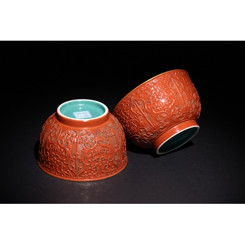 102 - A Pair of Chinese Carved Red-Ground Porcelain Bowls, with Four Character Marks to the Base.

This pa... 