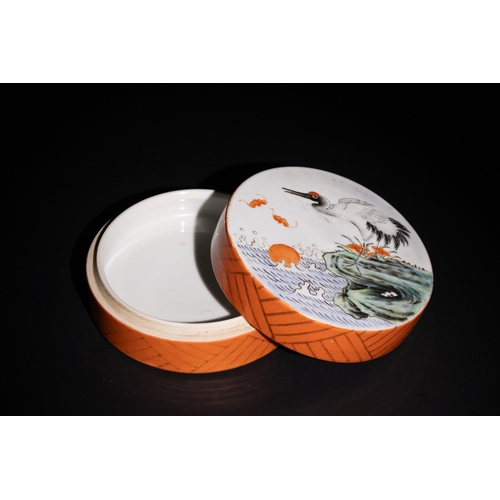 107 - A Chinese Porcelain Lidded Box with Crane and Waves Design.

A circular lidded box featuring a crane... 