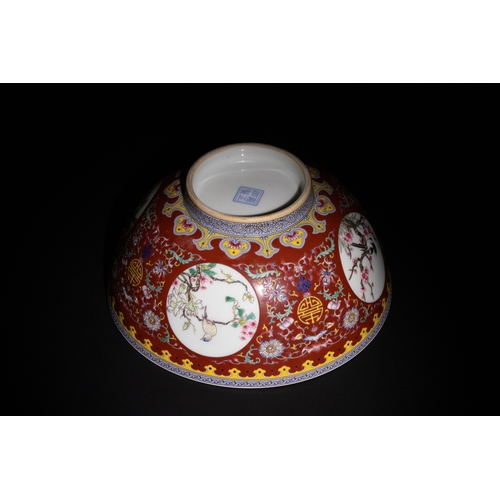 109 - A Chinese Porcelain Red Ground Bowl with Floral and Bird Motifs & Four Character Marks to the Base.
... 