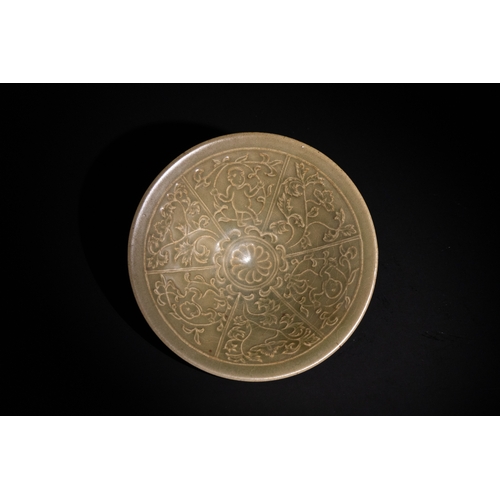 114 - A Chinese Celadon Glazed Bowl with Floral Relief Motifs.

A celadon-glazed bowl featuring intricate ... 