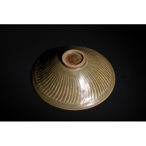 114 - A Chinese Celadon Glazed Bowl with Floral Relief Motifs.

A celadon-glazed bowl featuring intricate ... 