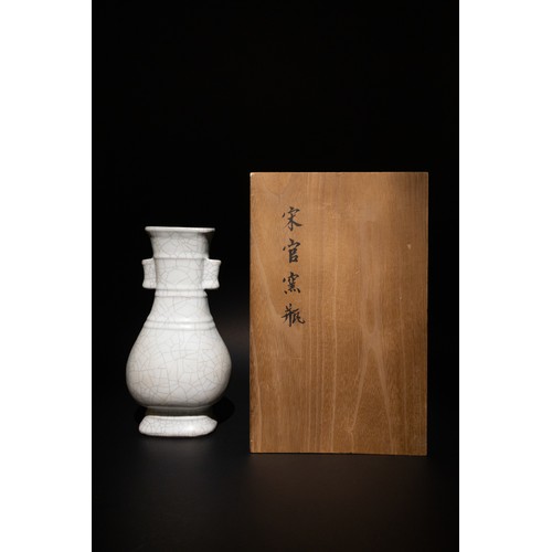 127 - A Chinese Crackle Glaze Vase with Wooden Box.

The vase is characterized by its symmetrical dual han... 