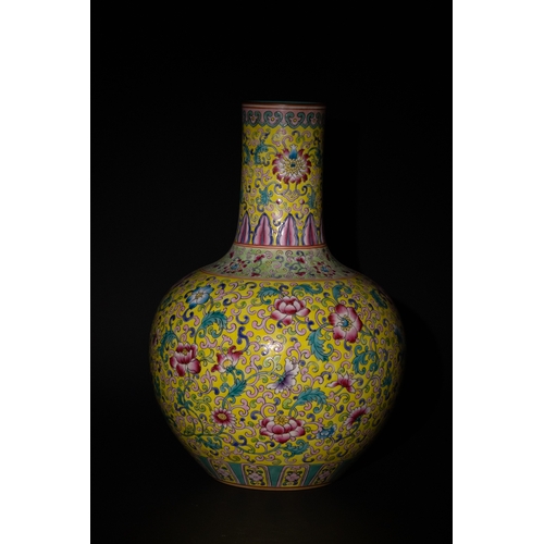 131 - A Chinese Yellow Ground Famille Bottle Vase with Floral and Scrollwork Design.

A vase with a yellow... 