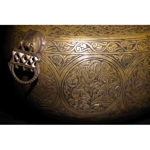 9 - A Qajar Brass Kashkul Beggar's Bowl with Engraved Decorative Panels and Calligraphy.

This Qajar bra... 