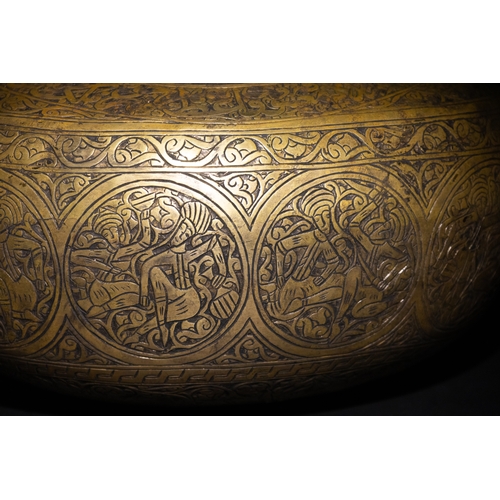 9 - A Qajar Brass Kashkul Beggar's Bowl with Engraved Decorative Panels and Calligraphy.

This Qajar bra... 