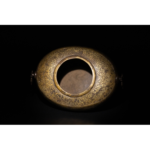 9 - A Qajar Brass Kashkul Beggar's Bowl with Engraved Decorative Panels and Calligraphy.

This Qajar bra... 