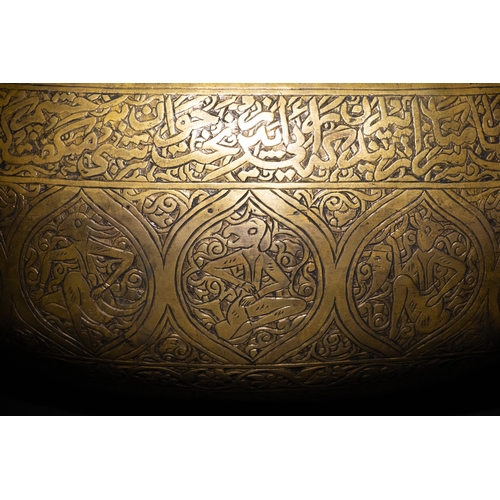 10 - A Qajar Brass Kashkul Beggar's Bowl with Engraved Decorative Panels and Calligraphy.

This Qajar bra... 