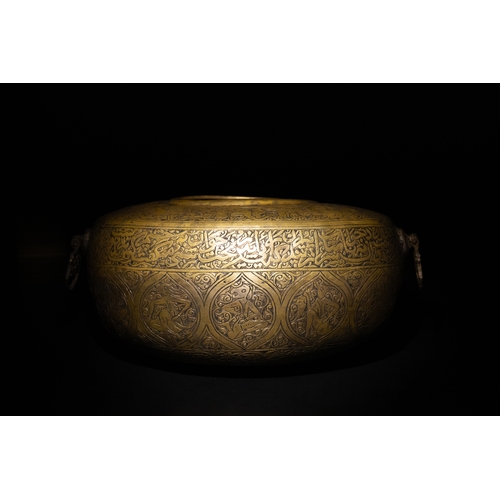 10 - A Qajar Brass Kashkul Beggar's Bowl with Engraved Decorative Panels and Calligraphy.

This Qajar bra... 