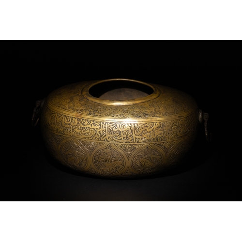 10 - A Qajar Brass Kashkul Beggar's Bowl with Engraved Decorative Panels and Calligraphy.

This Qajar bra... 