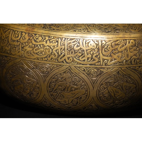 10 - A Qajar Brass Kashkul Beggar's Bowl with Engraved Decorative Panels and Calligraphy.

This Qajar bra... 