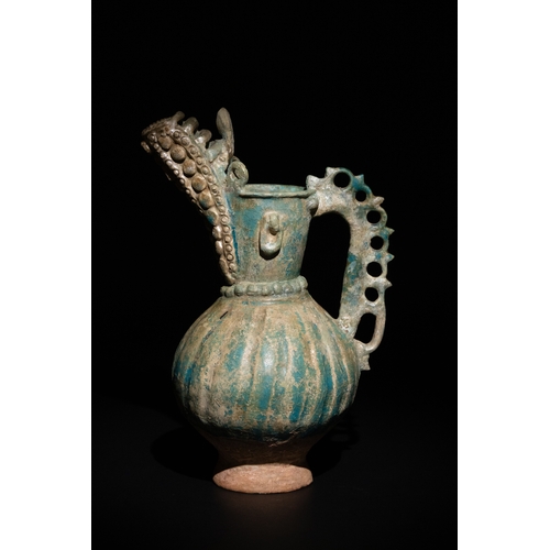 11 - An Islamic Khorassan Glazed Ceramic Ewer with Ornate Spout and Handle, 12th Century.

This ceramic e... 