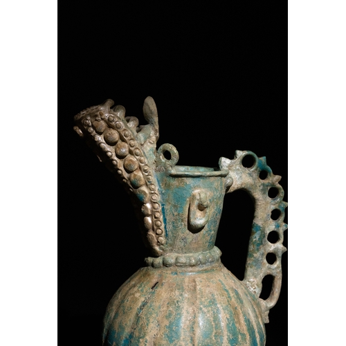 11 - An Islamic Khorassan Glazed Ceramic Ewer with Ornate Spout and Handle, 12th Century.

This ceramic e... 