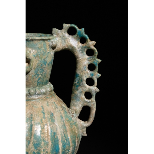 11 - An Islamic Khorassan Glazed Ceramic Ewer with Ornate Spout and Handle, 12th Century.

This ceramic e... 