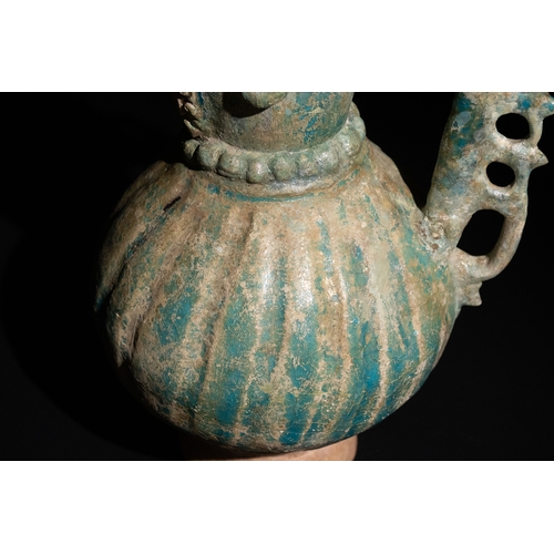 11 - An Islamic Khorassan Glazed Ceramic Ewer with Ornate Spout and Handle, 12th Century.

This ceramic e... 