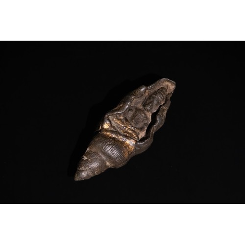 308 - **NO RESERVE**

An Tibetan Buddha Figure in a Conch Shell, 19th-20th Century.

A sculptural represen... 