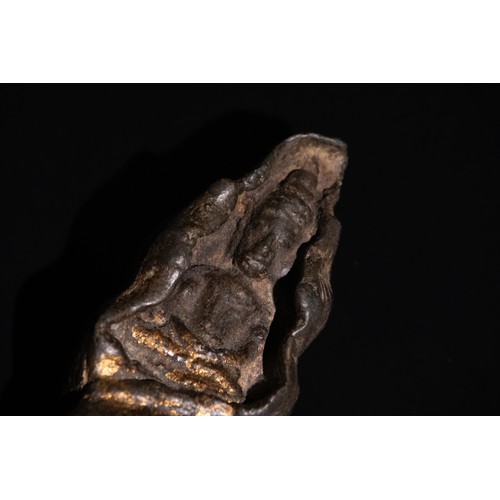 308 - **NO RESERVE**

An Tibetan Buddha Figure in a Conch Shell, 19th-20th Century.

A sculptural represen... 