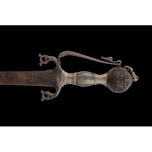 16 - A Timurid-Mughal Inscribed Sword with Silver Wirework.

A Timurid-Mughal saber featuring a deeply cu... 