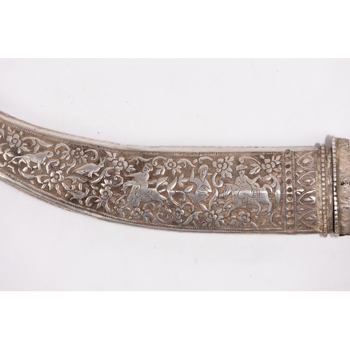 17 - A Qajar Silver Inlaid Dagger with Hunting Scene Motifs.

A Qajar dagger featuring a curved blade and... 